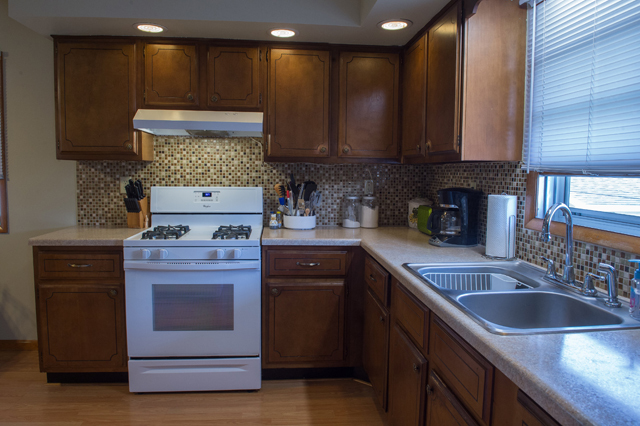 504 East Cleveland Street Spring Valley, IL 61362 - Photo 8 of 18 a kitchen with stainless steel appliances granite countertop a sink stove and cabinets