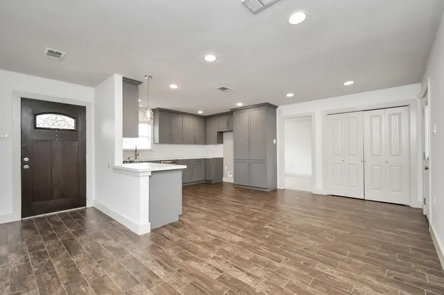 a view of kitchen with cabinets and wooden floor