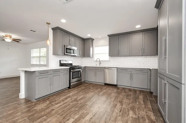 a kitchen with a sink cabinets and stainless steel appliances