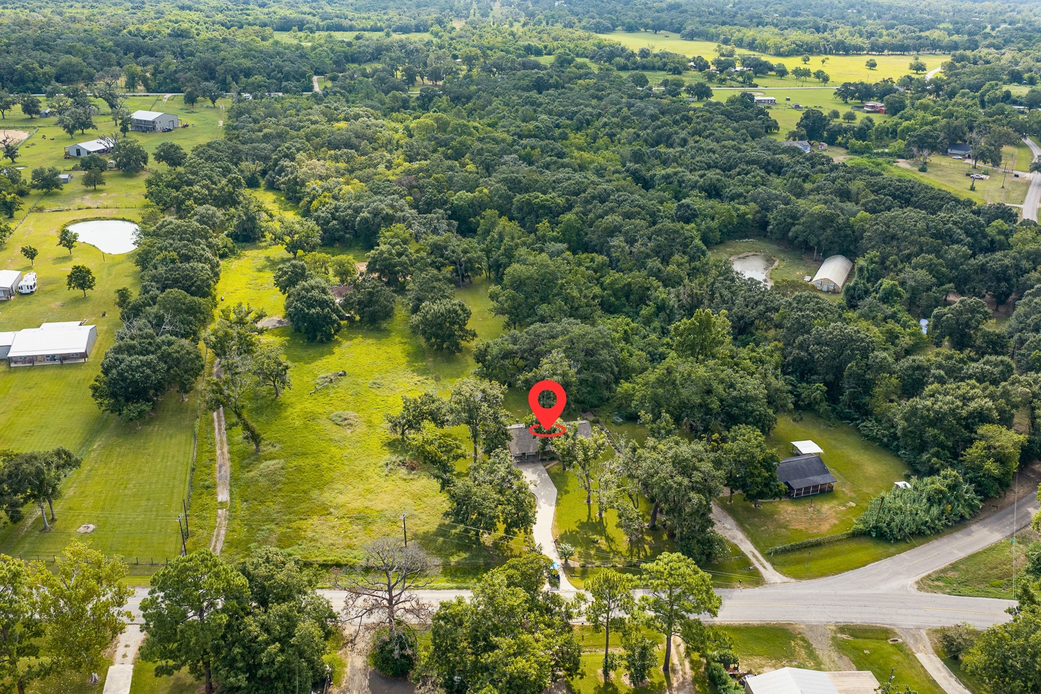 1971 FM 522 Road Brazoria, TX 77422 - Photo 23 of 26 A long concrete driveway extends from the road to the home and two-car garage, creating a generous approach with plenty of parking space.