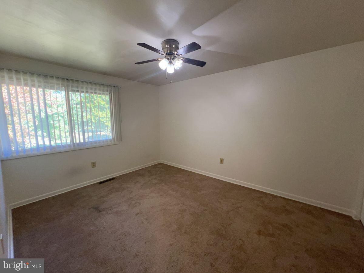 1128 Taney Avenue, Unit 1128 Frederick, MD 21702 - Photo 5 of 7 an empty room with windows and fan