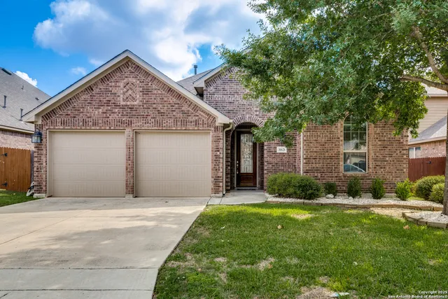 a front view of a house with a garden and yard
