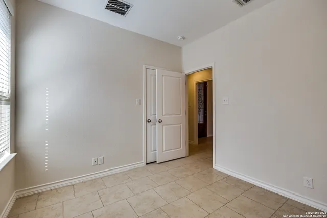 an empty room with closet area