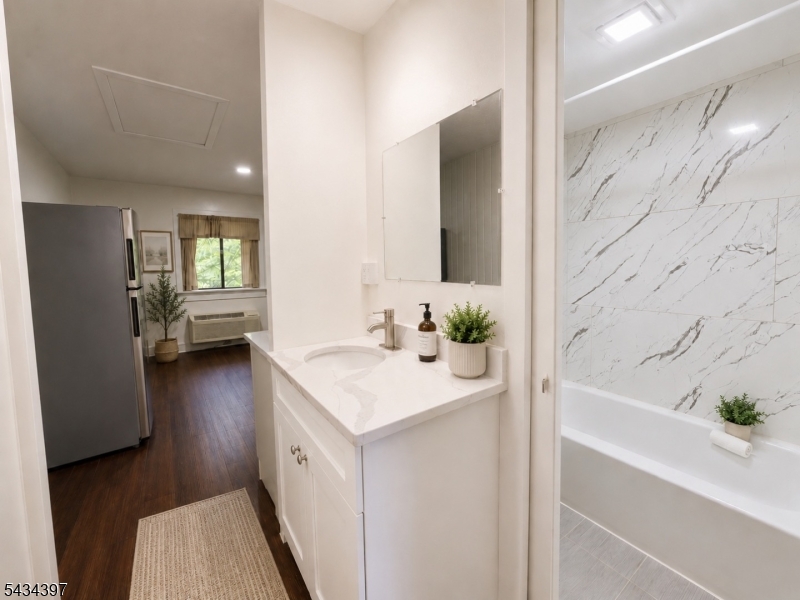 207 Old Chimney Ridge Road, Unit L Montague, NJ 07827 - Photo 10 of 14 a bathroom with a bathtub a sink a mirror and a shower