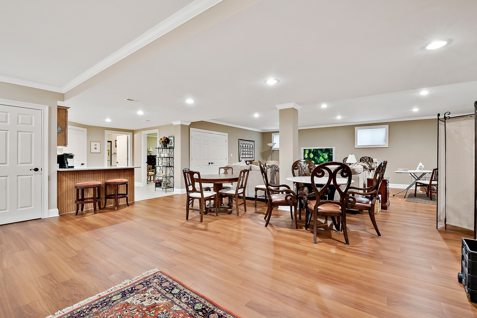 1036 Ridgeview Drive Inverness, IL 60010 - Photo 25 of 35 a group of people sitting in a living room with kitchen view and a couch