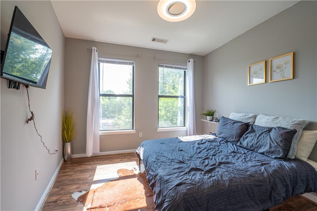898 Oak Street Southwest, Unit 1410 Atlanta, GA 30310 - Photo 14 of 31 a large bed sitting in a bedroom next to a window
