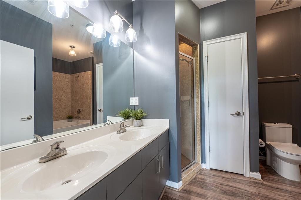 898 Oak Street Southwest, Unit 1410 Atlanta, GA 30310 - Photo 20 of 31 a bathroom with a sink vanity granite and a mirror