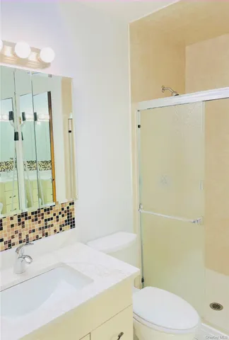 a bathroom with a bathtub shower sink and toilet