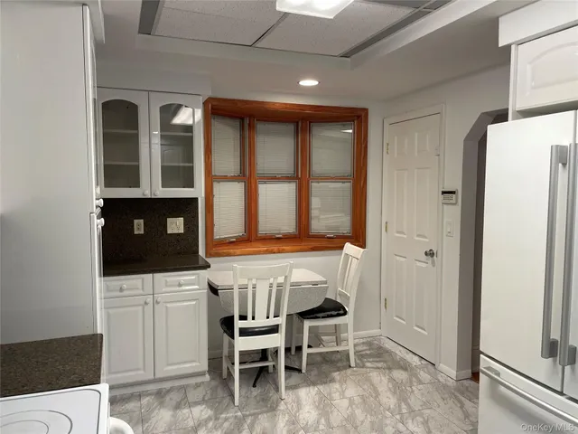 a kitchen that has a table and chairs in it