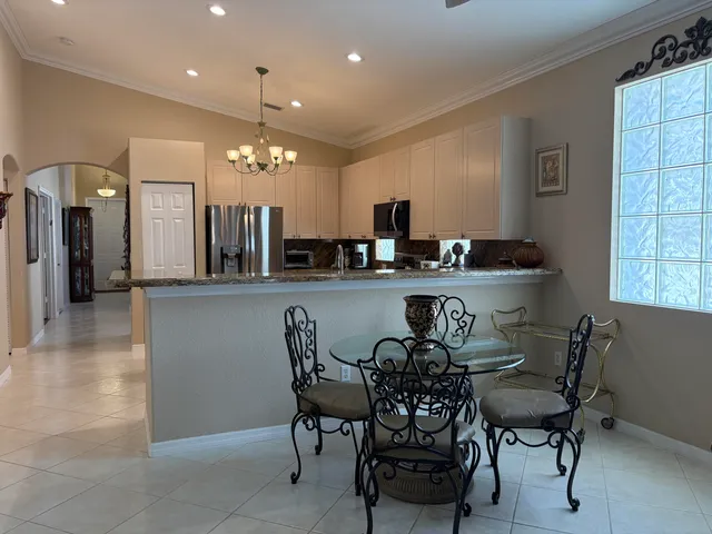 a view of a dining room with furniture and window