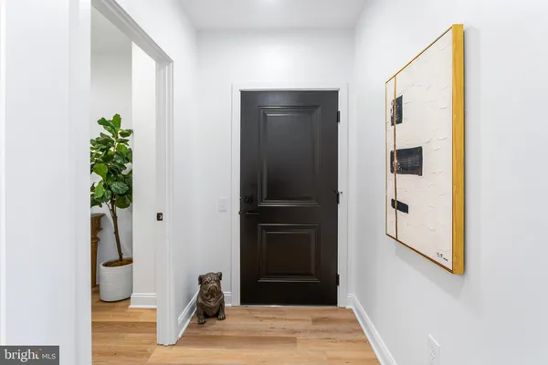 a view of a hallway to rooms and stairs