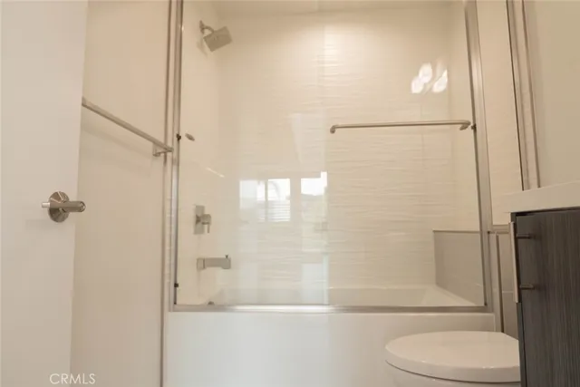 a bathroom with a shower a toilet and a shower