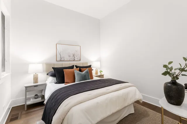 a bedroom with a bed and a potted plant