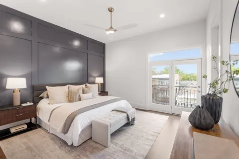 a bedroom with a bed and a large window