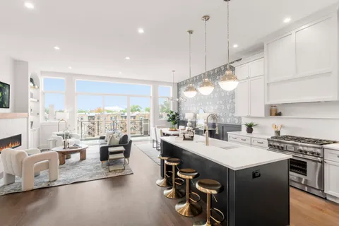 a kitchen with counter top space a sink appliances and cabinets