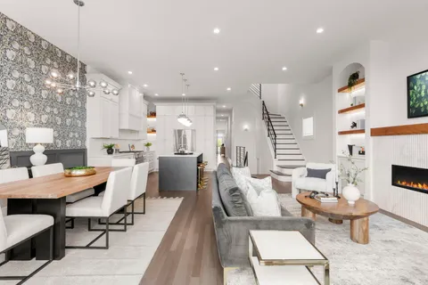 a large kitchen with a table and chairs