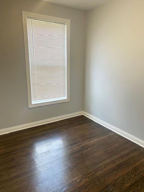 627 East 89th Place, Unit 2 Chicago, IL 60619 - Photo 7 of 9 a view of an empty room with wooden floor and a window