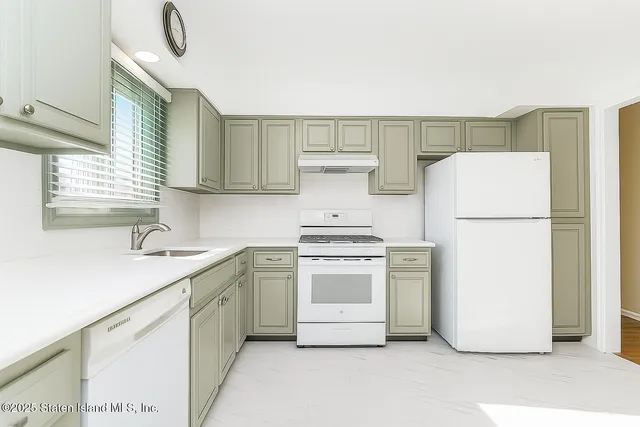 a kitchen with a white cabinets and white appliances