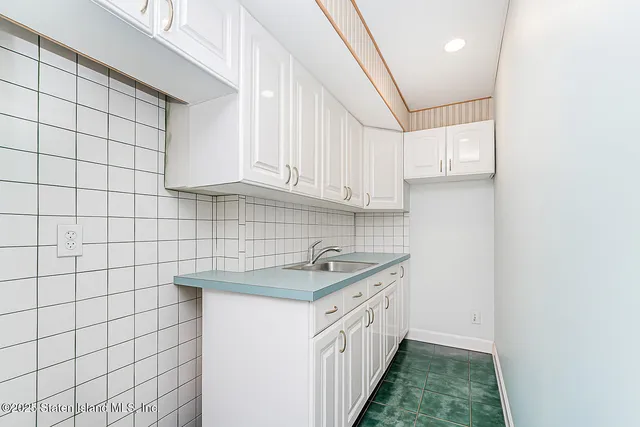 a kitchen with a sink and cabinets