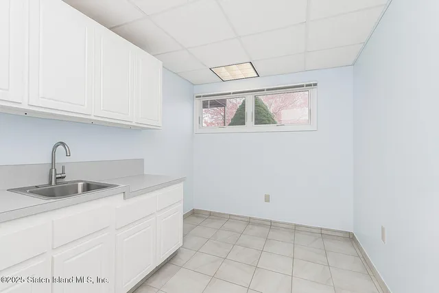 a kitchen with a sink cabinets and utility