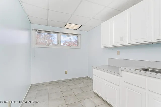 a kitchen with white cabinets and a sink