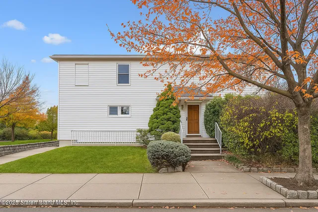 a front view of a house with a garden