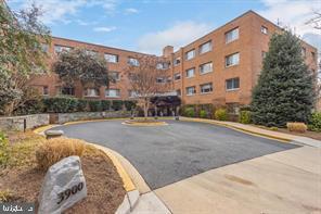 a view of tall building with large trees