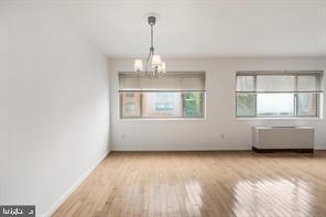 3900 Tunlaw Road Northwest, Unit 305 Washington, DC 20007 - Photo 11 of 32 a view of an empty room with wooden floor and a window