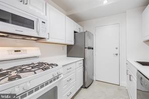 3900 Tunlaw Road Northwest, Unit 305 Washington, DC 20007 - Photo 20 of 32 a kitchen with stainless steel appliances granite countertop white cabinets and a stove a oven with white countertops