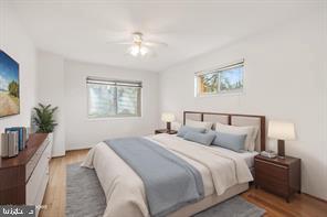3900 Tunlaw Road Northwest, Unit 305 Washington, DC 20007 - Photo 24 of 32 a bedroom with bed and a night stand