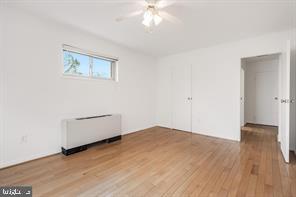 3900 Tunlaw Road Northwest, Unit 305 Washington, DC 20007 - Photo 25 of 32 an empty room with wooden floor and windows