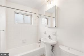 3900 Tunlaw Road Northwest, Unit 305 Washington, DC 20007 - Photo 27 of 32 a bathroom with a sink a toilet and shower