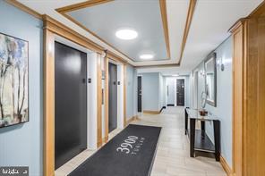 3900 Tunlaw Road Northwest, Unit 305 Washington, DC 20007 - Photo 5 of 32 a hallway with dining area and glass doors
