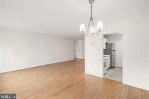 3900 Tunlaw Road Northwest, Unit 305 Washington, DC 20007 - Photo 6 of 32 a view of a room with wooden floor and entryway