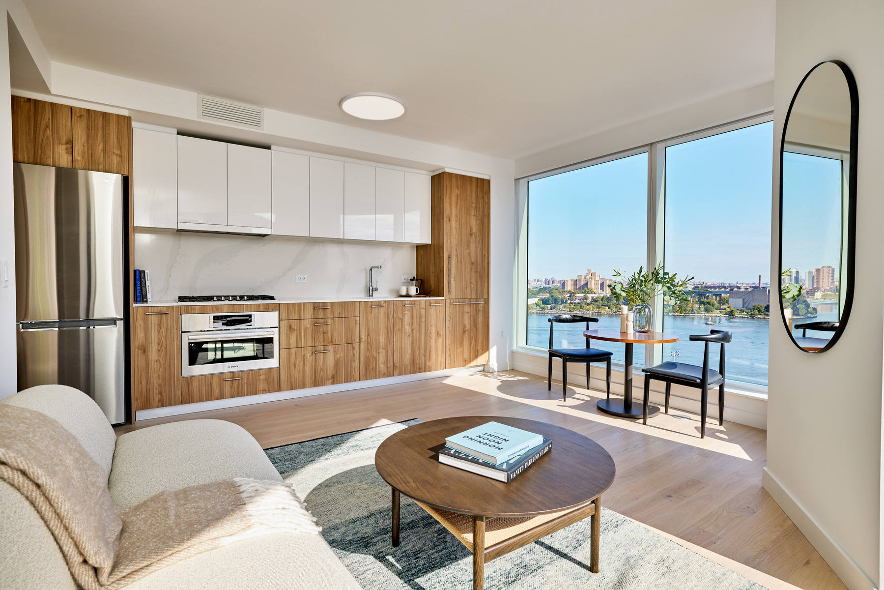 20 Halletts Point, Unit 22405 Queens, NY 11102 - Photo 13 of 47 a living room with furniture a large window and a table