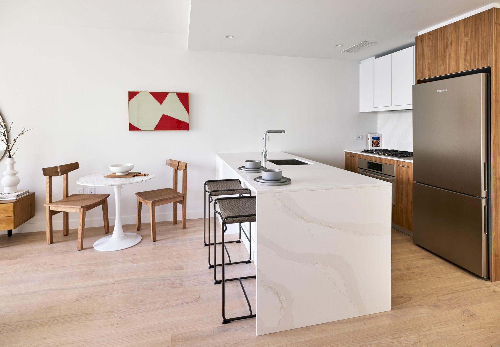 20 Halletts Point, Unit 22405 Queens, NY 11102 - Photo 17 of 47 a kitchen with stainless steel appliances kitchen island a table chairs stove and sink