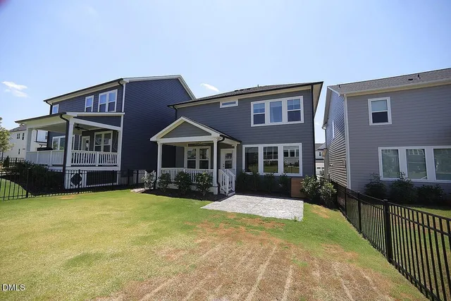 a front view of a house with yard and porch