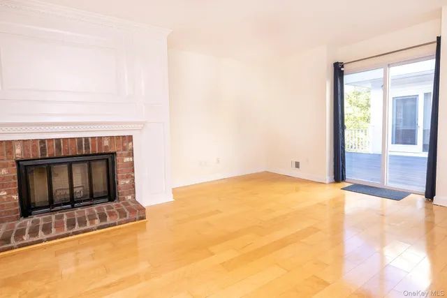 a view of empty room with window and fireplace