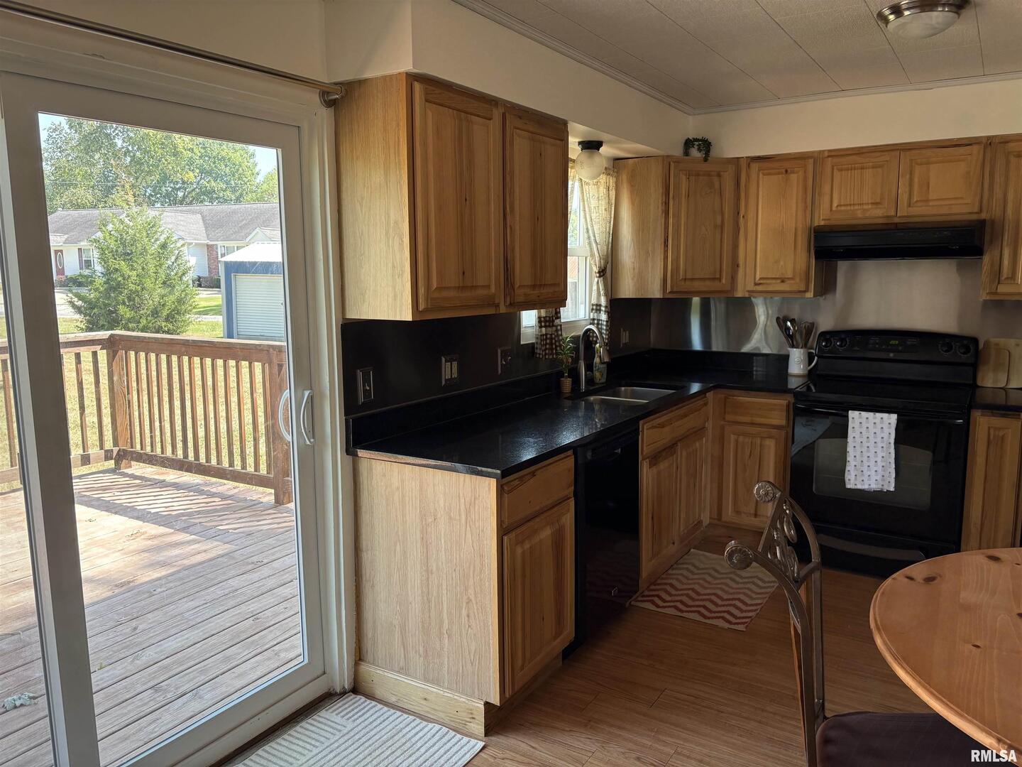 100 North 35th Street Herrin, IL 62948 - Photo 17 of 35 a kitchen with a sink a stove cabinets and a wooden floor