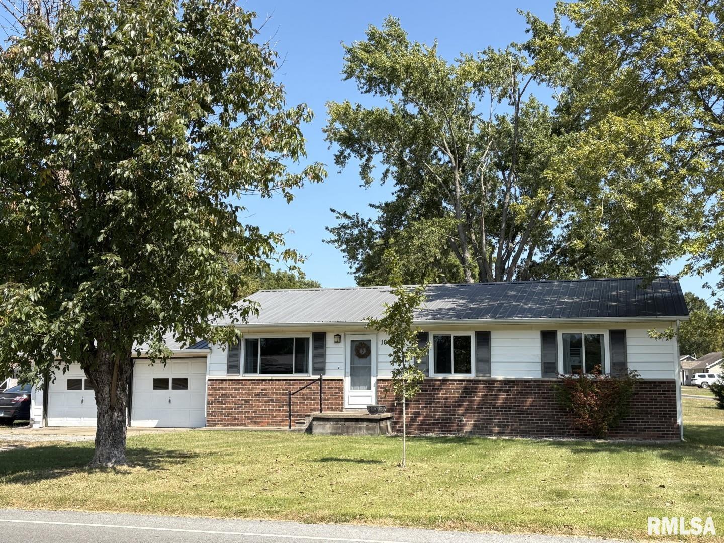100 North 35th Street Herrin, IL 62948 - Photo 35 of 35 a front view of a house with a garden and tree