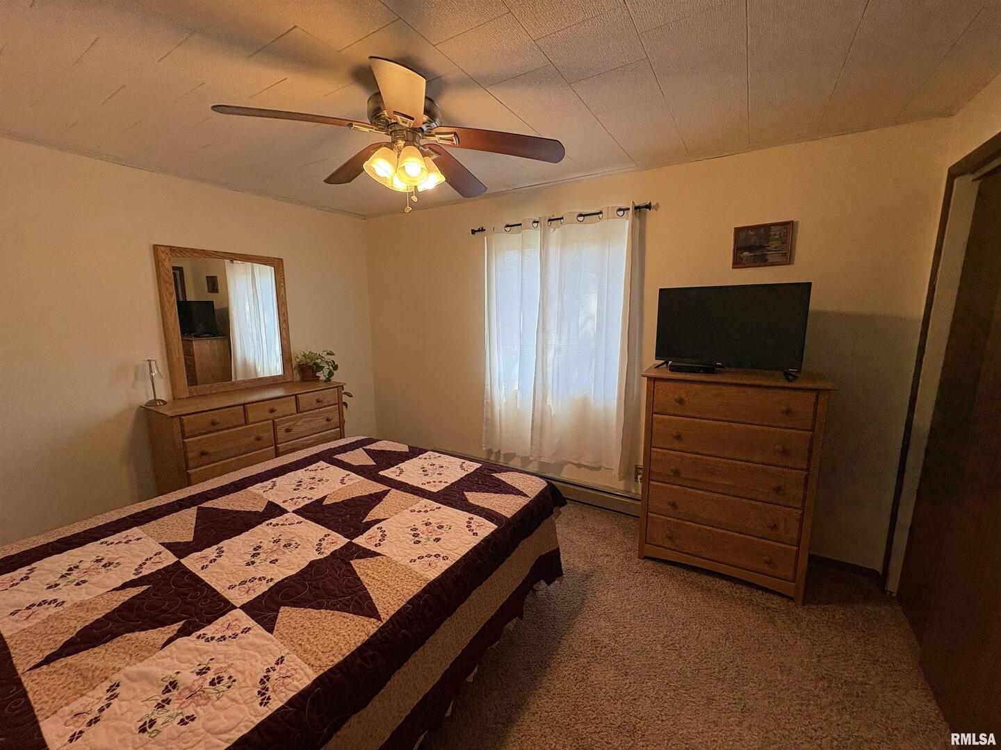 100 North 35th Street Herrin, IL 62948 - Photo 10 of 35 a bedroom with a bed and a flat tv screen on dresser