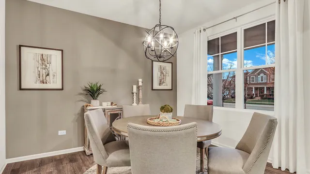 a view of a dining room with furniture and chandelier