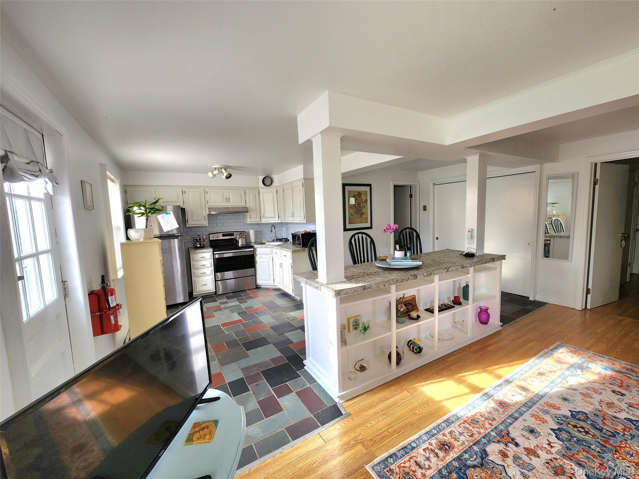 12 Traver Road Staatsburg, NY 12580 - Photo 3 of 11 a living room with stainless steel appliances kitchen island granite countertop furniture and a wooden floor
