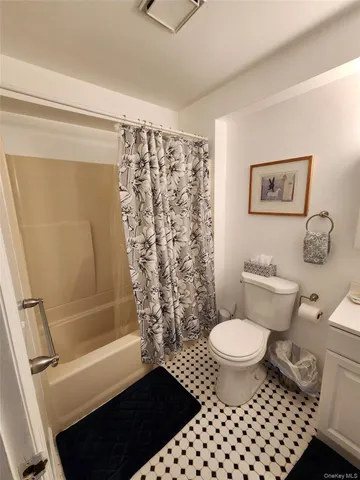 a bathroom with a toilet sink and shower