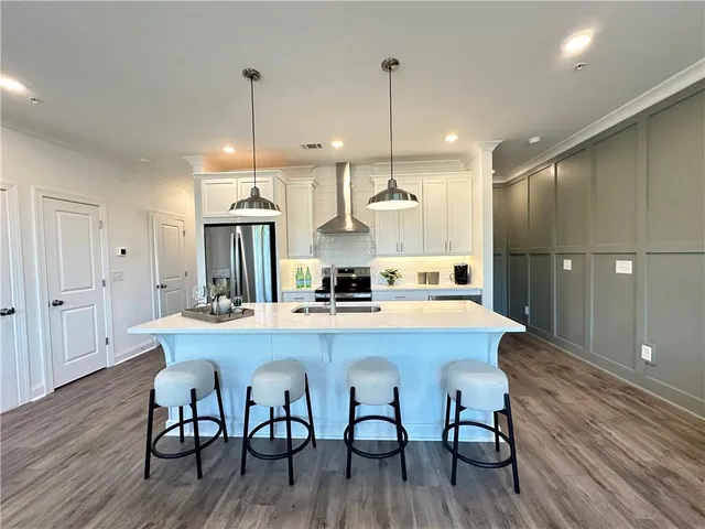 a large kitchen with a table and chairs
