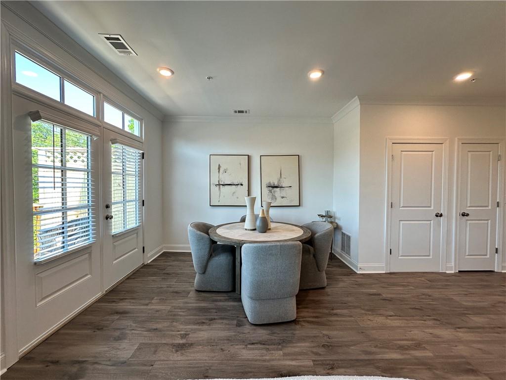 530 Alice Way, Unit D7 Cumming, GA 30040 - Photo 11 of 56 a dining room with kitchen island stainless steel appliances furniture stove and wooden floor