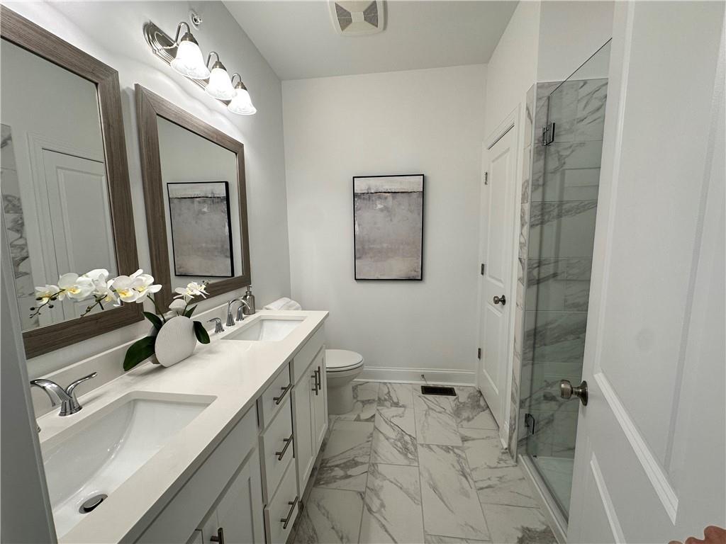 530 Alice Way, Unit D7 Cumming, GA 30040 - Photo 23 of 56 a bathroom with a sink vanity mirror and toilet