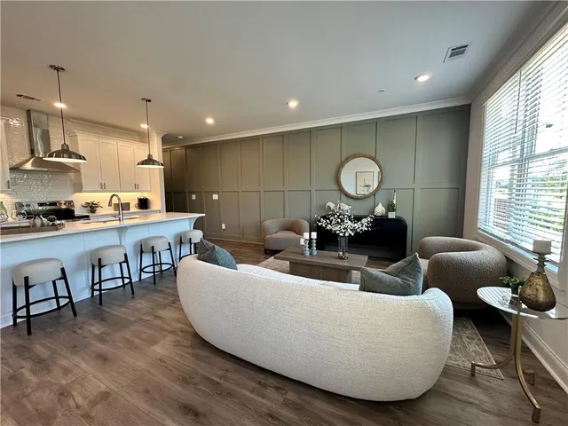 a living room with furniture and wooden floor