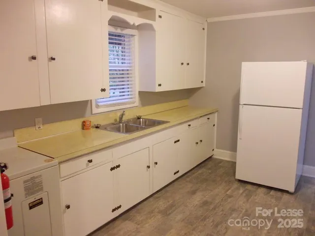 a bathroom with a granite countertop sink and a white cabinet