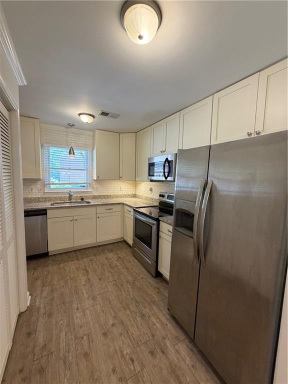 2912 Webb Bridge Road Alpharetta, GA 30009 - Photo 5 of 12 a kitchen with stainless steel appliances a refrigerator sink and cabinets